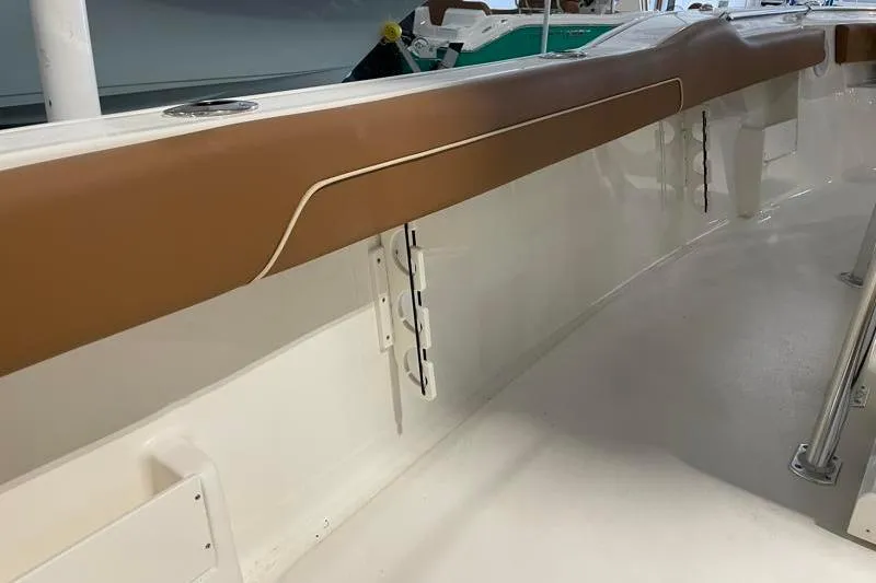 Slide: The Image of 2025 Key West 239 FS boat interior with brown cushioned side panel. - 44