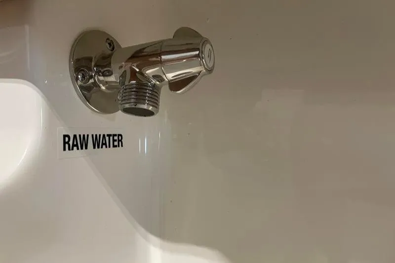 Slide: The Image of Chrome faucet labeled "Raw Water" on Key West 239 FS boat, 2025 model. - 45