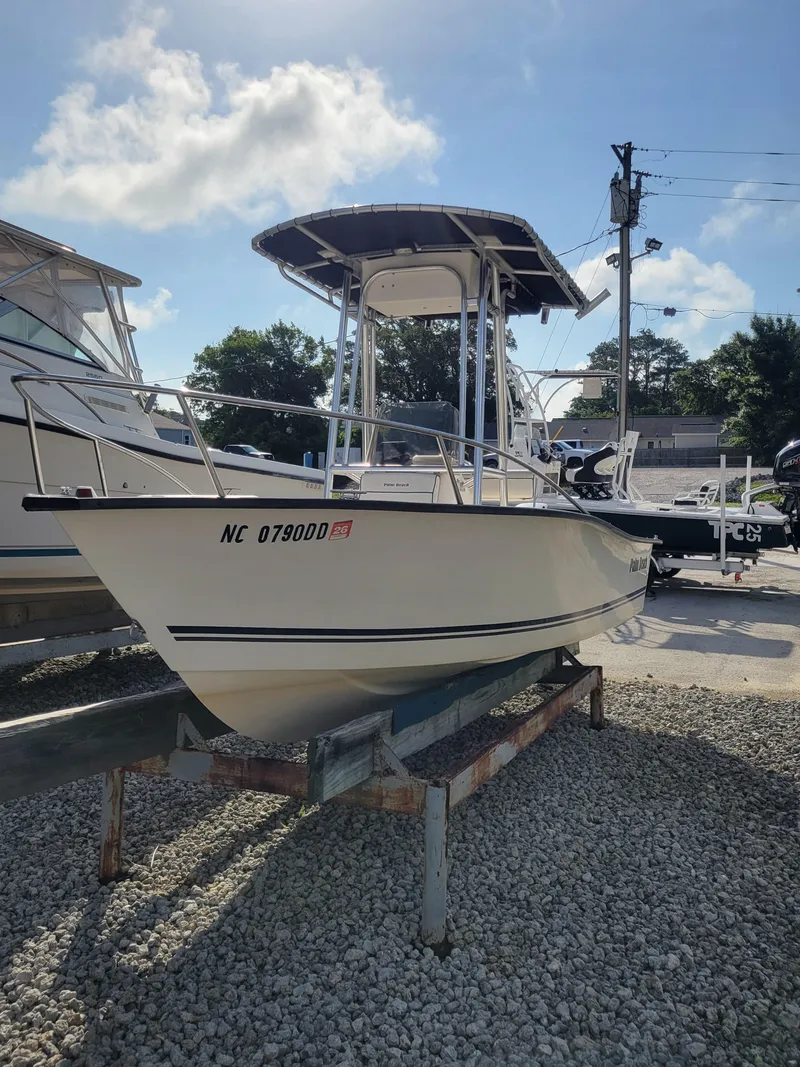 Slide: The Image of 2005 Palm Beach 181 boat on trailer under clear sky. - 0