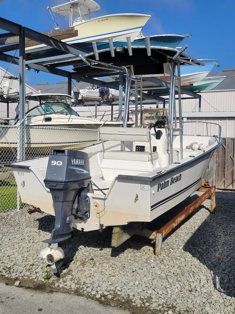 Slide: The Image of 2005 Palm Beach 181 boat with Yamaha 90 engine, docked on gravel. - 1