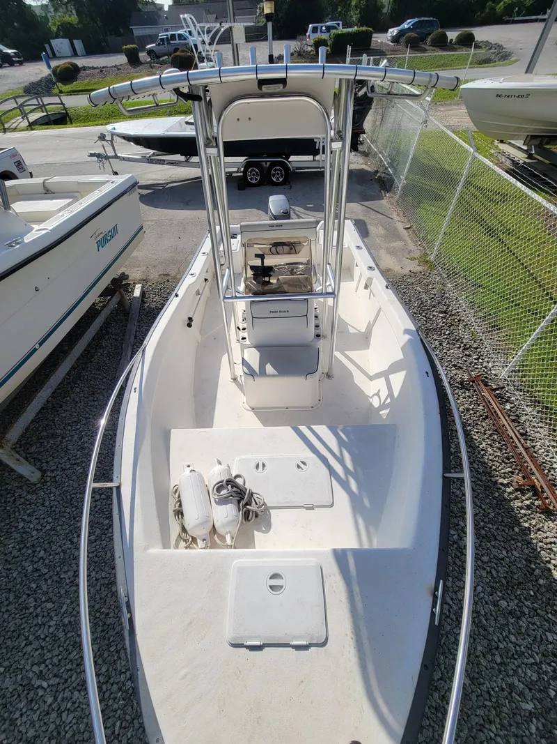 Slide: The Image of 2005 Palm Beach 181 boat with center console, docked on gravel. - 3