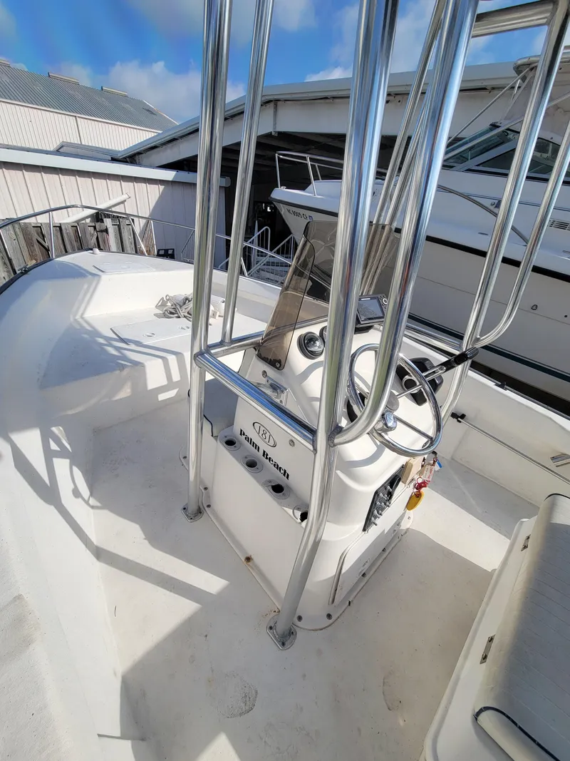 Slide: The Image of 2005 Palm Beach 181 boat interior with steering console and chrome railings. - 6