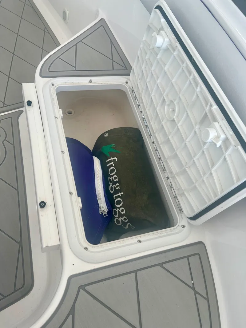 Slide: The Image of Open storage compartment with Frogg Toggs bag on a boat. - 5