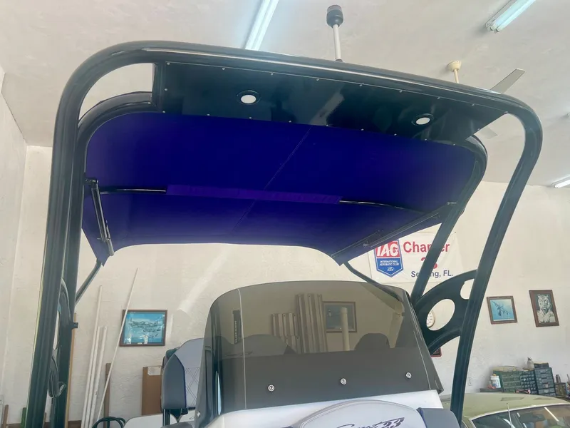 Slide: The Image of 2018 Concept 23 boat with blue canopy in a garage. - 8