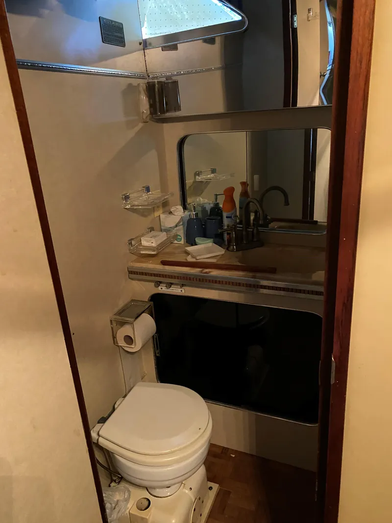 Slide: The Image of 1985 Chris-Craft 381 Catalina bathroom with toilet, sink, and mirror. - 10