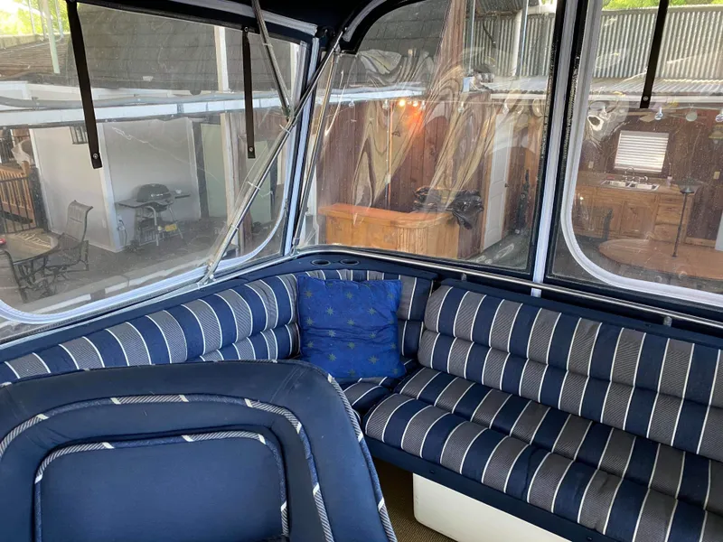 Slide: The Image of 1985 Chris-Craft 381 Catalina interior with striped seating and blue cushions. - 5