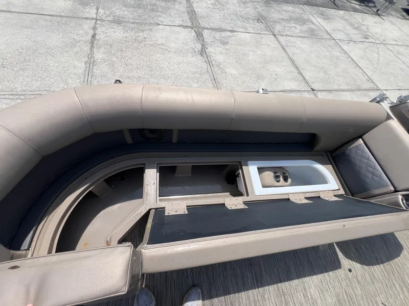 Slide: The Image of 2022 Bennington 22 LS boat seating with storage compartments and cup holders. - 13