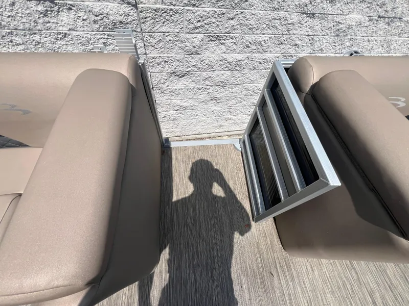 Slide: The Image of 2022 Bennington 22 LS boat interior with beige seating and a foldable ladder. - 17