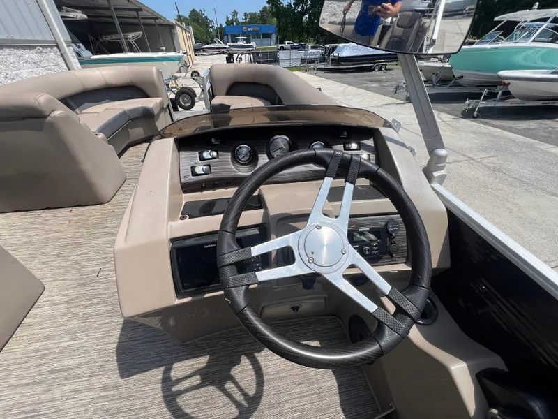 Slide: The Image of 2022 Bennington 22 LS boat dashboard with steering wheel and controls. - 7