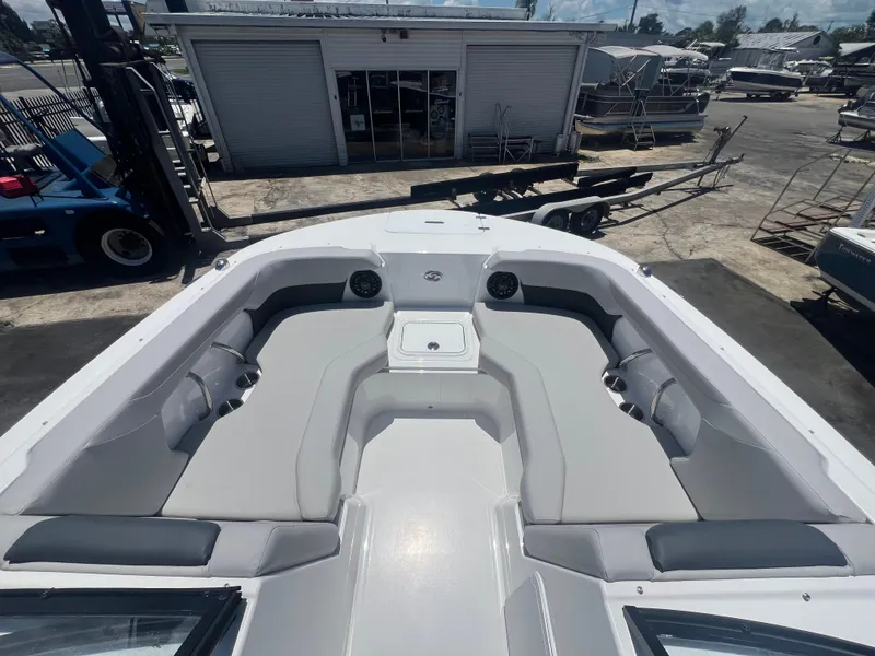 Slide: The Image of 2025 Hurricane SunDeck Sport 2050 OB boat with spacious seating, docked at a marina. - 5