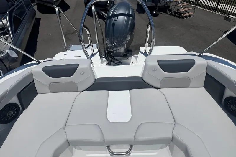 Slide: The Image of 2025 Hurricane SunDeck Sport 2050 OB boat interior with cushioned seating and outboard motor. - 9