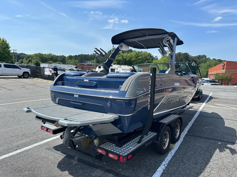 Slide: The Image of Blue MB F22 Tomcat Alpha 2022 boat on trailer in parking lot. - 4