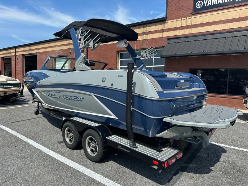 Slide: The Image of 2022 MB F22 Tomcat Alpha boat on trailer, parked outside a brick building. - 6