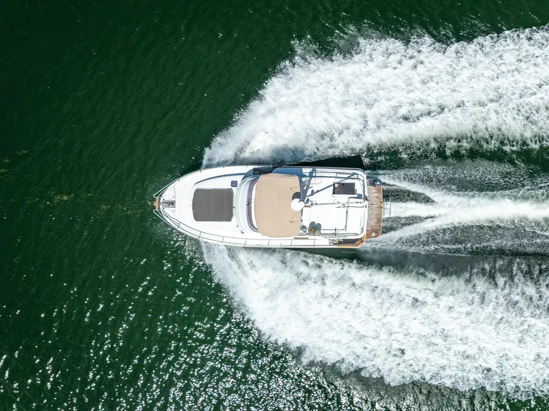 Slide: The Image of Aerial view of 2015 Beneteau Swift Trawler 34 cruising on open water. - 16