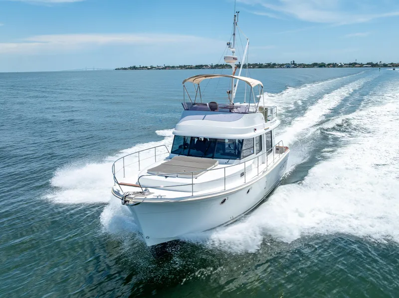 Slide: The Image of 2015 Beneteau Swift Trawler 34 cruising on open water, showcasing sleek design and performance. - 17