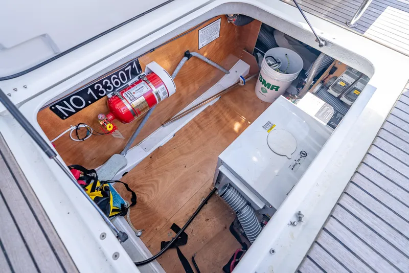 Slide: The Image of Engine compartment of 2015 Beneteau Swift Trawler 34 with fire extinguisher and equipment. - 23