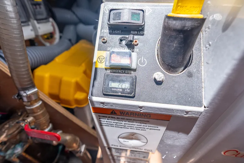 Slide: The Image of Control panel of a 2015 Beneteau Swift Trawler 34 with emergency stop and warning label. - 24