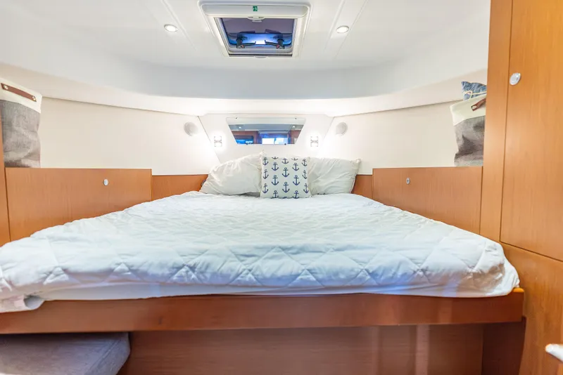 Slide: The Image of Cozy bedroom in 2015 Beneteau Swift Trawler 34 with nautical-themed decor. - 27
