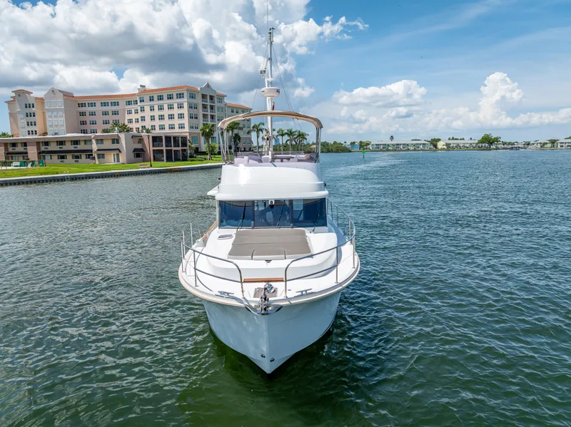 Slide: The Image of 2015 Beneteau Swift Trawler 34 on water, with buildings and blue sky in background. - 3