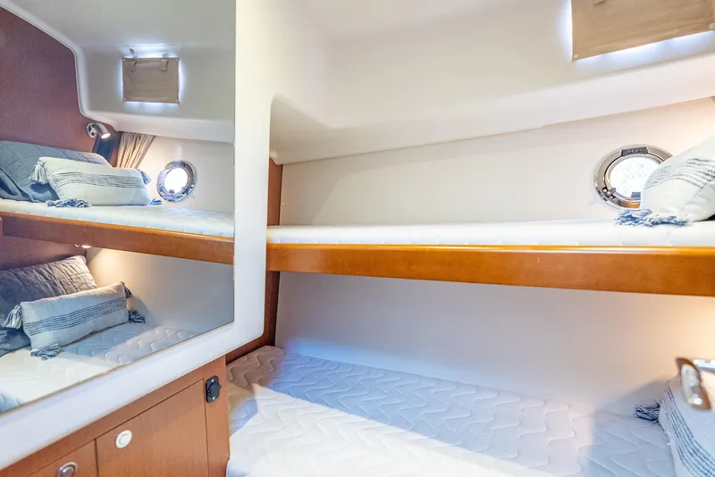 Slide: The Image of 2015 Beneteau Swift Trawler 34 cabin with cozy bunk beds and nautical decor. - 30