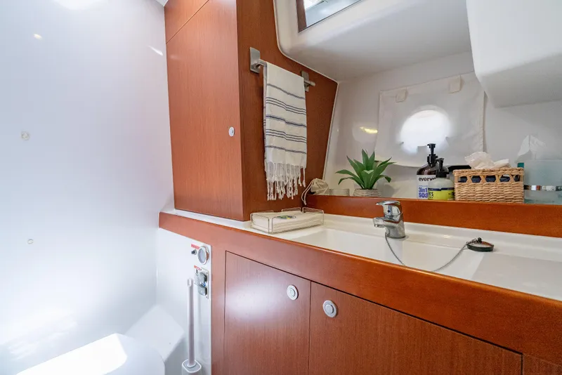 Slide: The Image of 2015 Beneteau Swift Trawler 34 bathroom with wooden cabinetry and modern fixtures. - 32