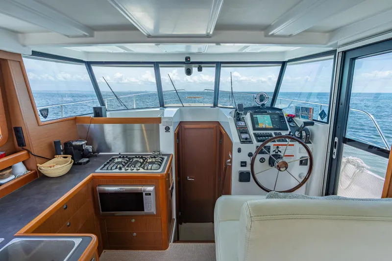 Slide: The Image of Interior view of 2015 Beneteau Swift Trawler 34 helm and kitchen area. - 37