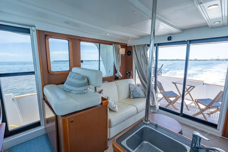 Slide: The Image of Interior of 2015 Beneteau Swift Trawler 34 with ocean view and comfortable seating. - 41