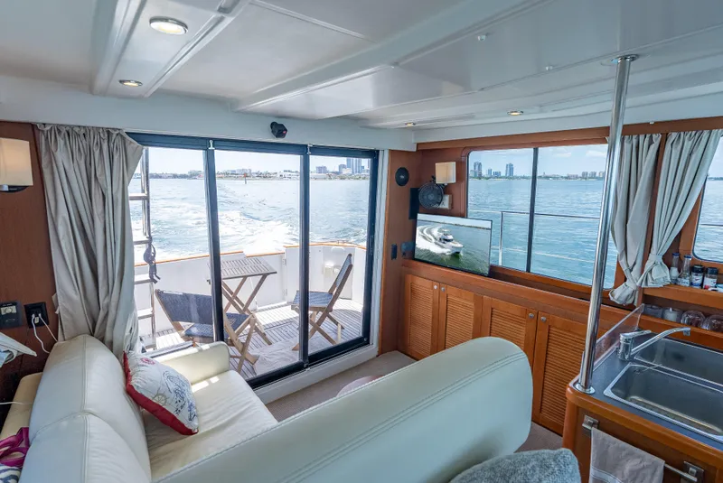 Slide: The Image of Interior of 2015 Beneteau Swift Trawler 34, featuring cozy seating, TV, and ocean view. - 42