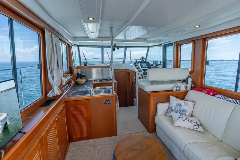 Slide: The Image of Interior of 2015 Beneteau Swift Trawler 34 with kitchen, seating, and ocean view. - 45