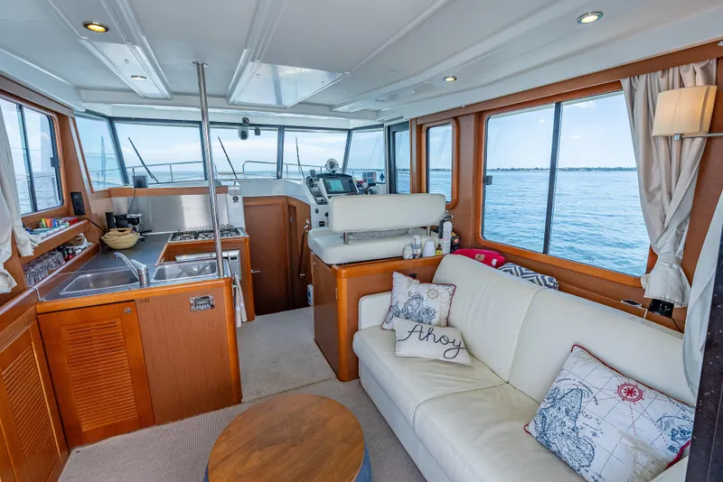 Slide: The Image of Interior of 2015 Beneteau Swift Trawler 34 with cozy seating and ocean view. - 48
