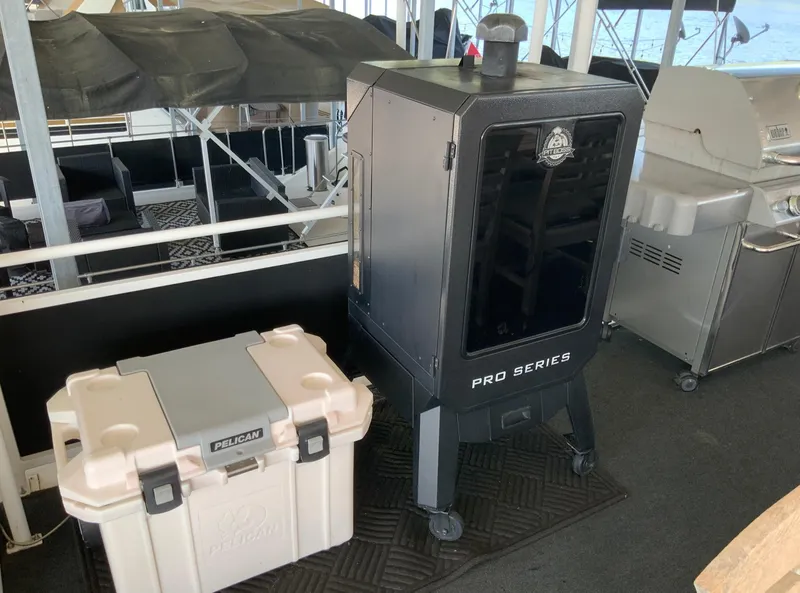 Slide: The Image of Pelican cooler and Pro Series smoker on 2007 Skipperliner 640 boat deck. - 12