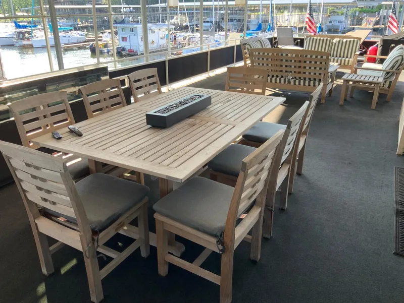 Slide: The Image of Luxurious 2007 Skipperliner 640 yacht deck with elegant wooden furniture and marina view. - 14