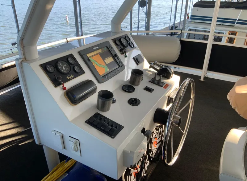 Slide: The Image of 2007 Skipperliner 640 helm with navigation controls and steering wheel on a boat. - 17