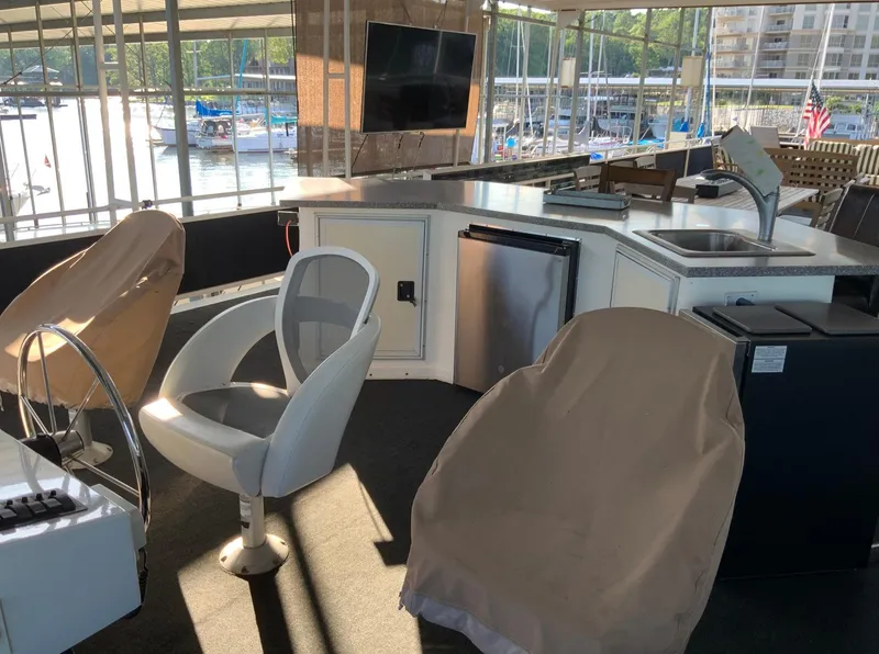 Slide: The Image of Interior of 2007 Skipperliner 640 yacht with covered seating and modern amenities. - 18