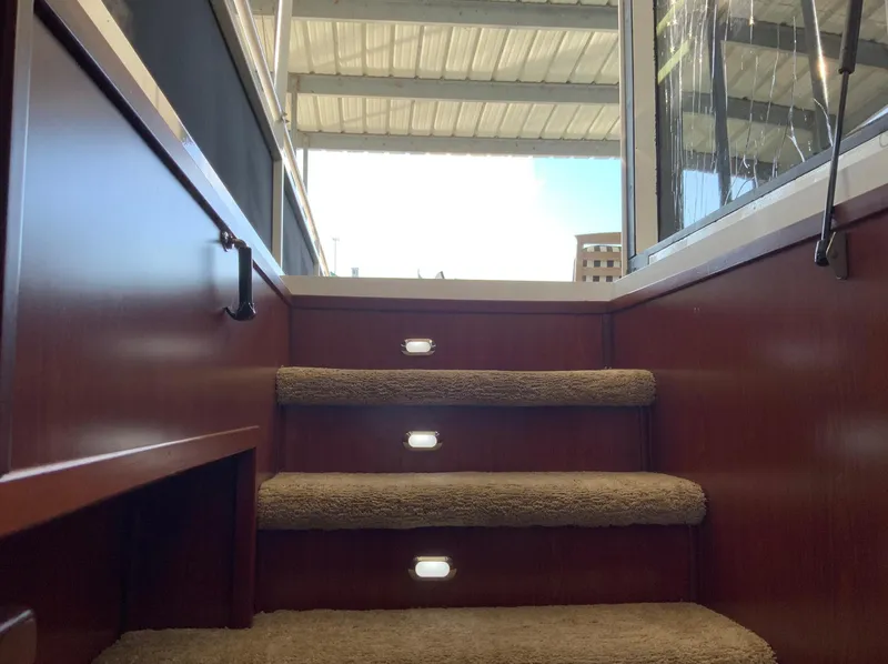 Slide: The Image of Staircase inside 2007 Skipperliner 640 yacht with carpeted steps and modern lighting. - 2