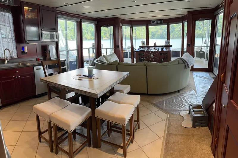 Slide: The Image of Luxurious 2007 Skipperliner 640 interior with kitchen, dining area, and scenic lake view. - 24