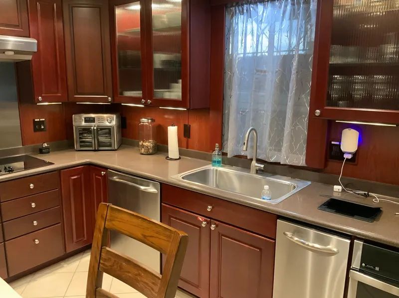 Slide: The Image of Modern kitchen with dark wood cabinets, stainless steel appliances, and a Skipperliner 640 model. - 28