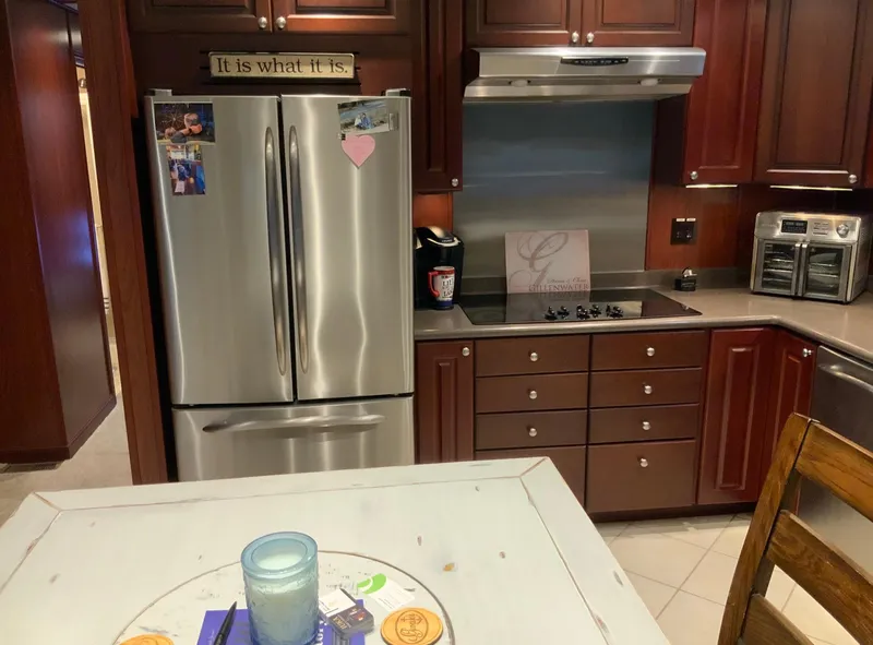 Slide: The Image of Modern kitchen with stainless steel appliances, wooden cabinets, and decorative sign. Skipperliner 640, 2007. - 29
