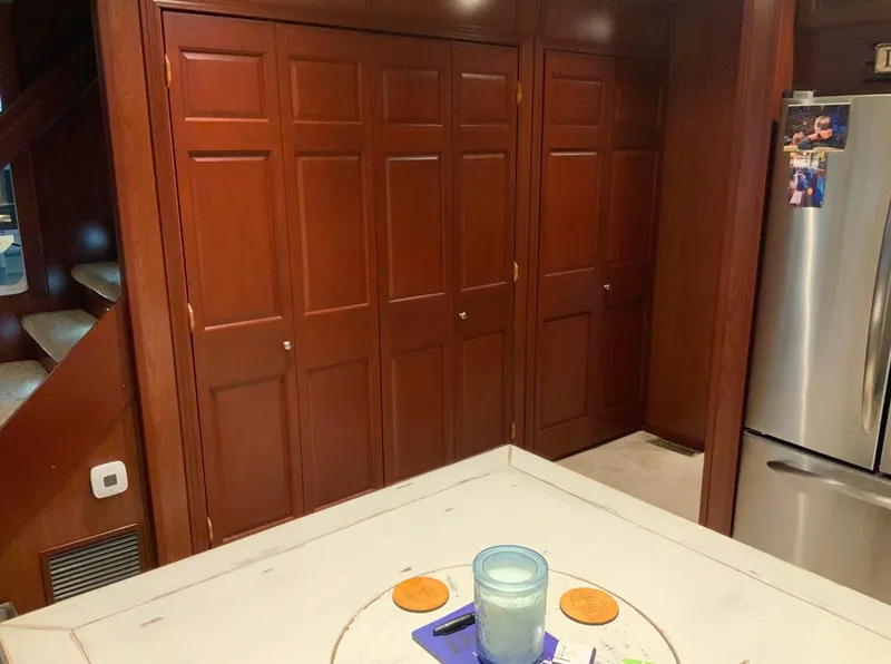 Slide: The Image of Interior of 2007 Skipperliner 640 with wooden cabinets and stainless steel refrigerator. - 30