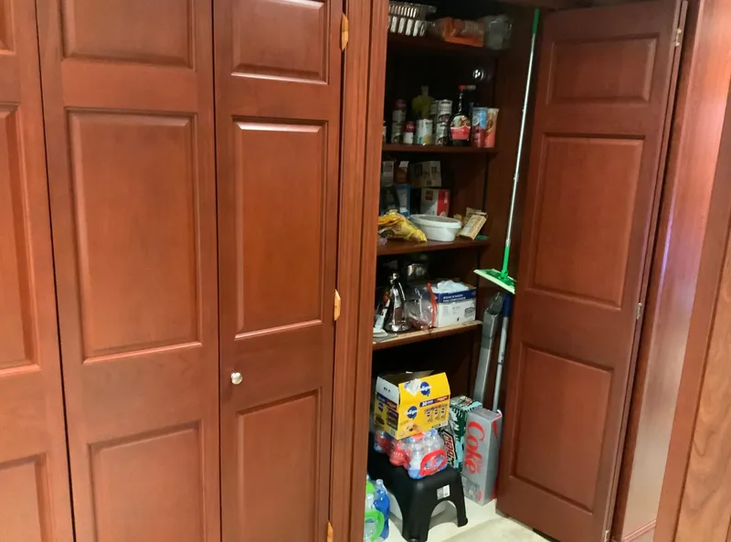 Slide: The Image of Wooden pantry with shelves stocked with groceries and cleaning supplies, Skipperliner 640, 2007. - 32