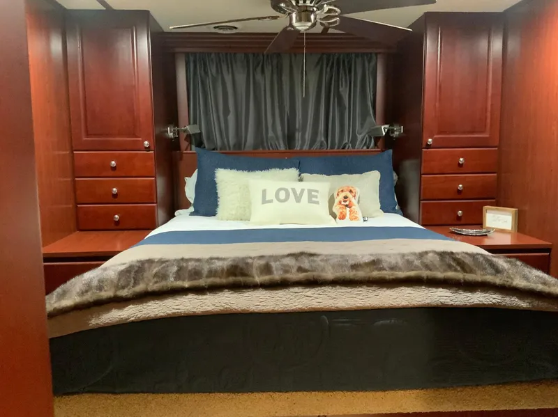 Slide: The Image of Luxurious bedroom in 2007 Skipperliner 640 with plush bedding and elegant wood cabinetry. - 37