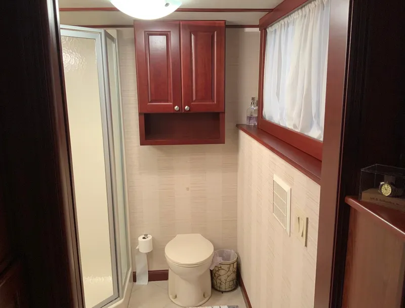 Slide: The Image of Luxurious bathroom in 2007 Skipperliner 640 with wooden cabinets and shower. - 43