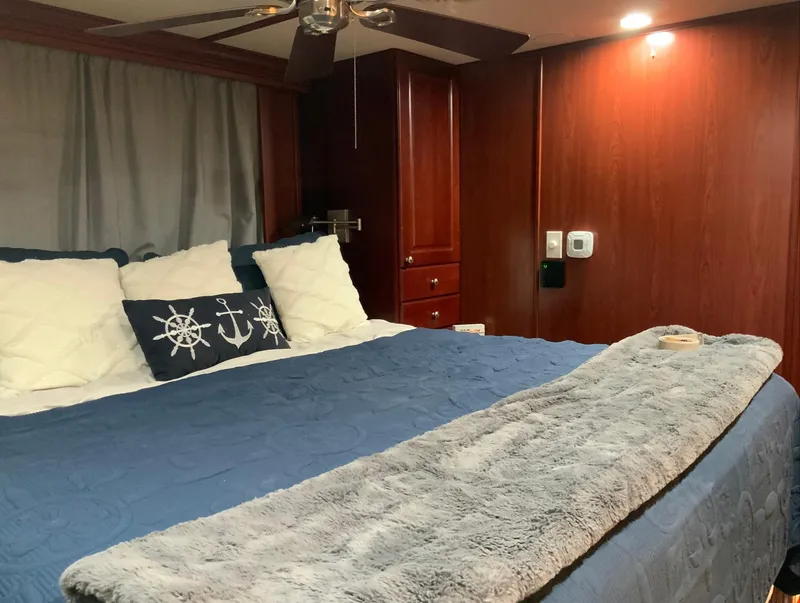 Slide: The Image of Luxurious bedroom interior of 2007 Skipperliner 640 with nautical-themed decor. - 50