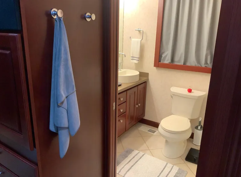 Slide: The Image of Bathroom interior of a 2007 Skipperliner 640 with wooden cabinetry and modern fixtures. - 52