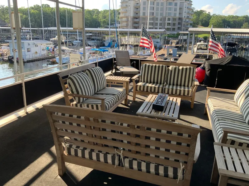 Slide: The Image of Upper deck of 2007 Skipperliner 640 with striped seating and marina view. - 6