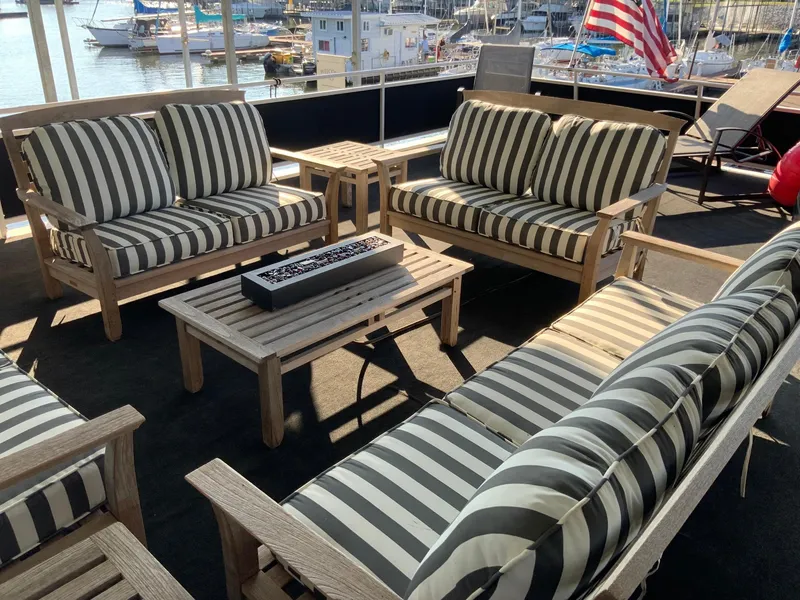 Slide: The Image of Outdoor seating area on a 2007 Skipperliner 640 with striped cushions and marina view. - 7