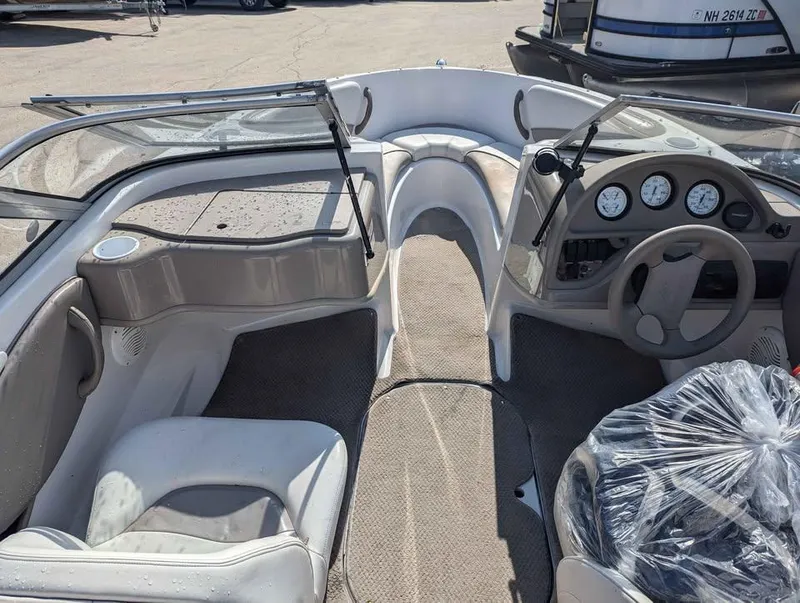 Slide: The Image of Interior of 2003 Four Winns Freedom 170 boat with steering wheel and seating. - 13