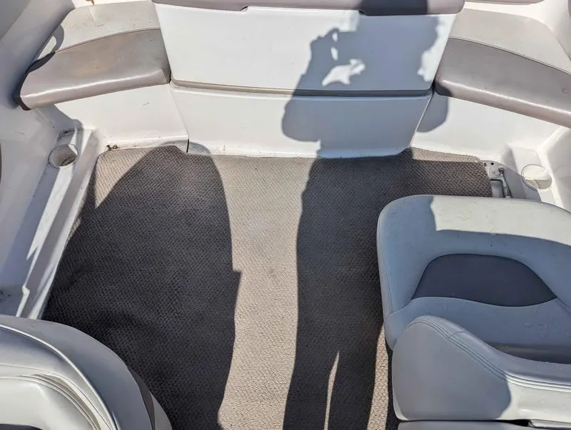 Slide: The Image of Interior of a 2003 Four Winns Freedom 170 boat with seating and carpeted floor. - 14