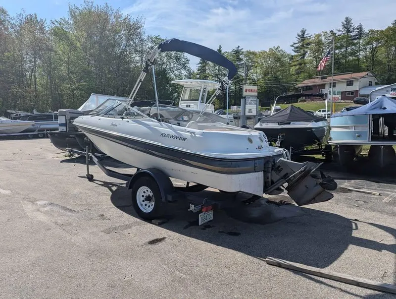 Slide: The Image of 2003 Four Winns Freedom 170 boat on trailer in outdoor lot. - 2