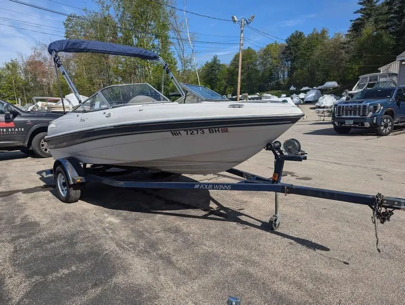 Slide: The Image of 2003 Four Winns Freedom 170 boat on trailer, parked outdoors. - 5